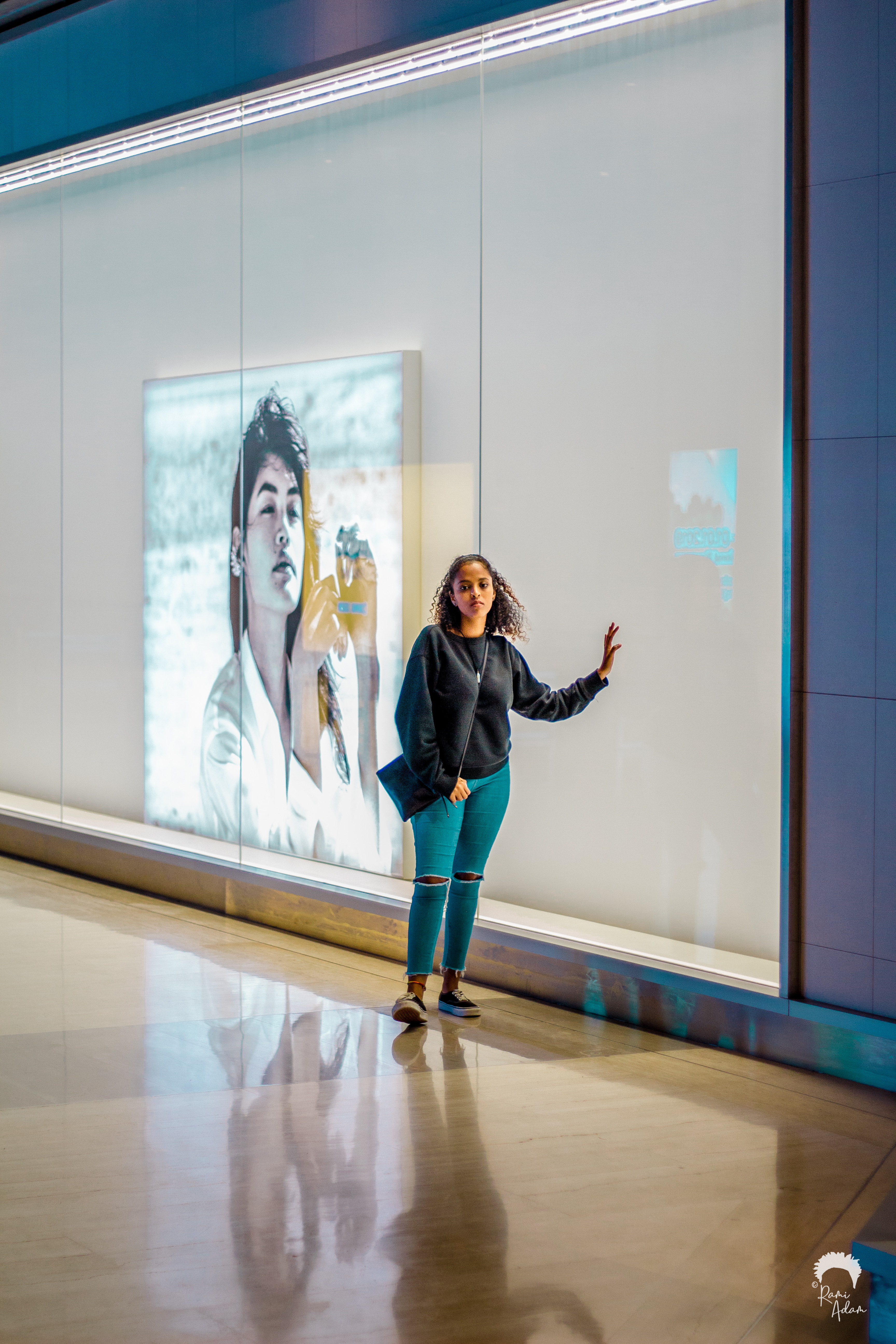 Woman posing at digital billboard