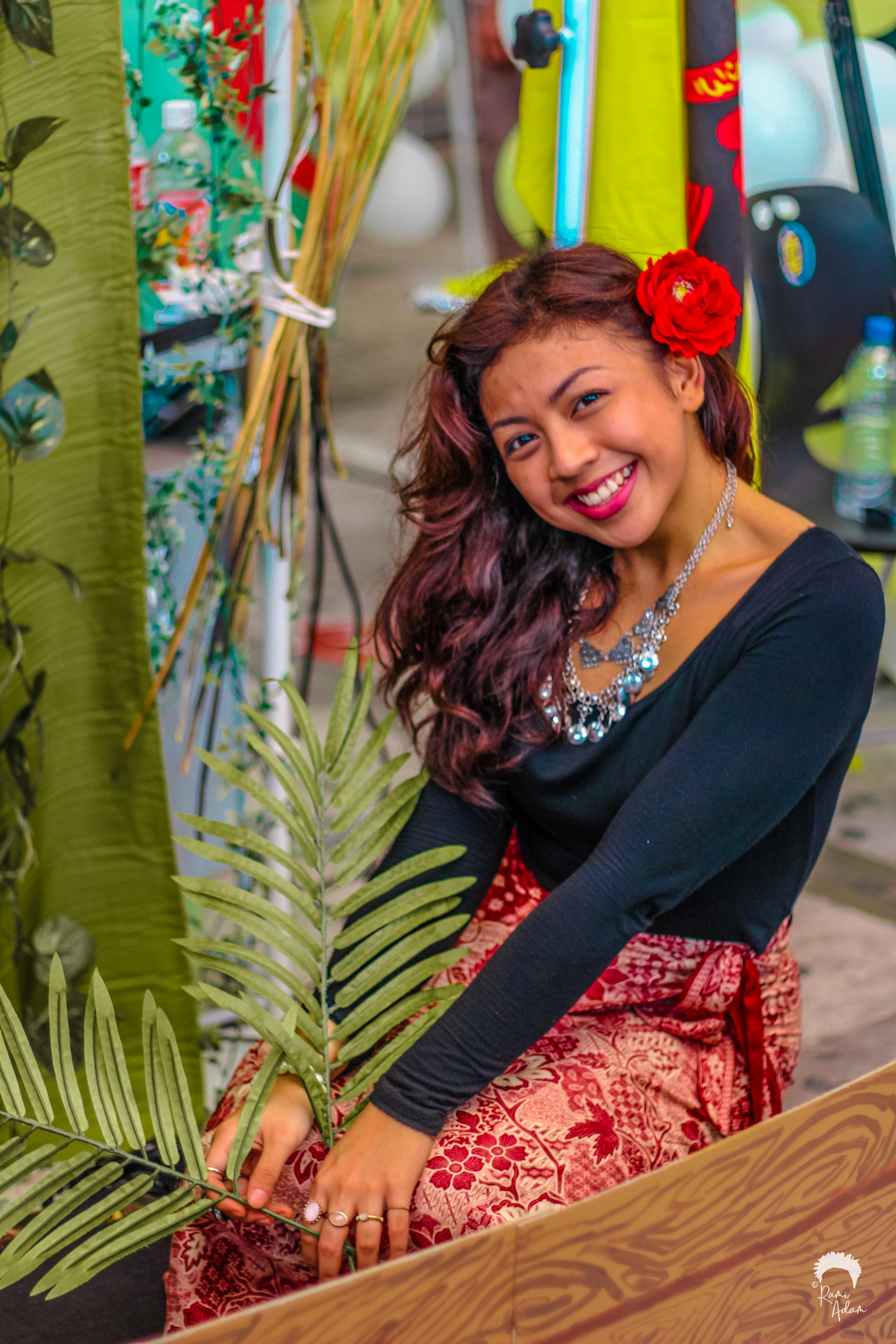 Woman with red flower at festival