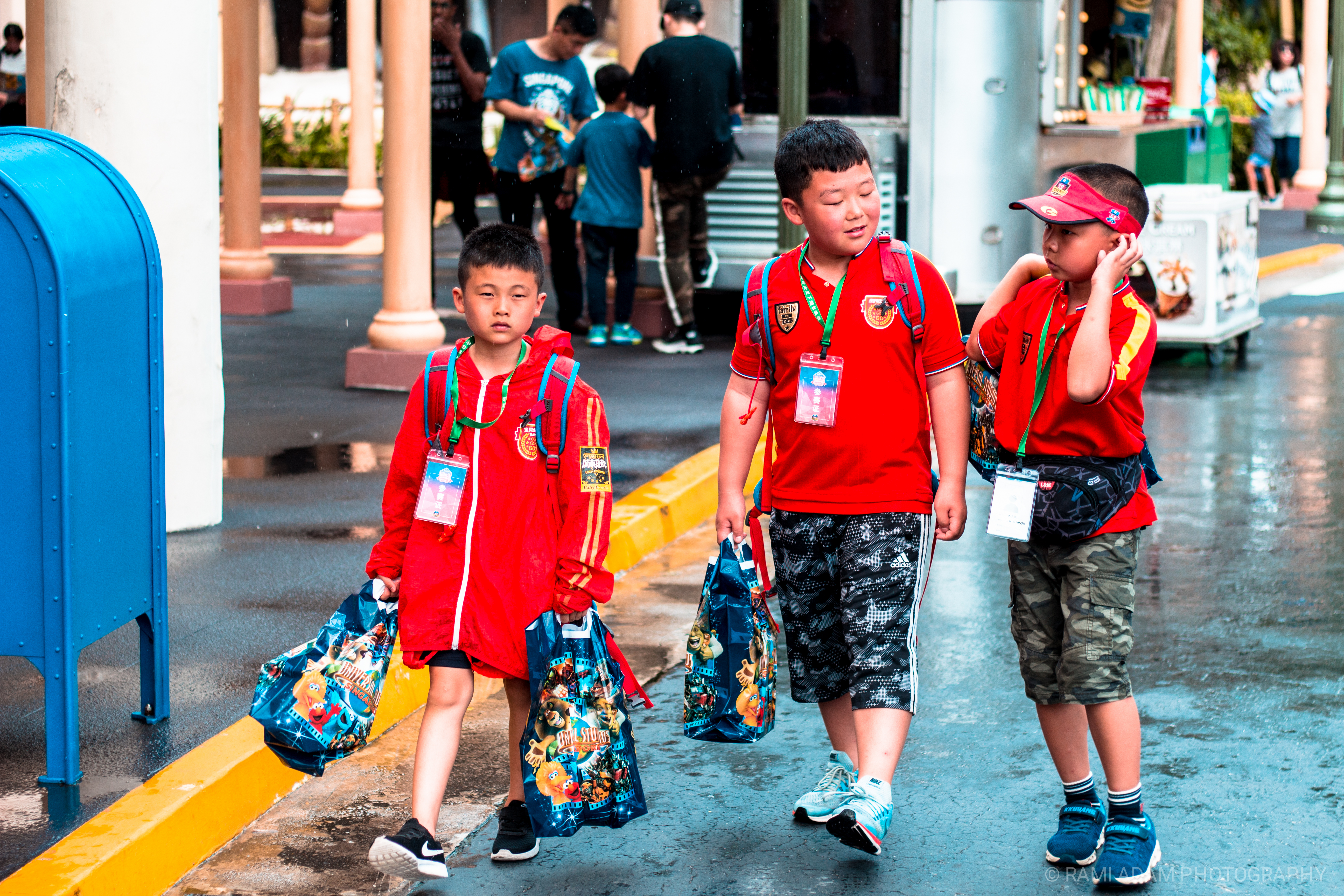 Three children walking in matching red uniforms
